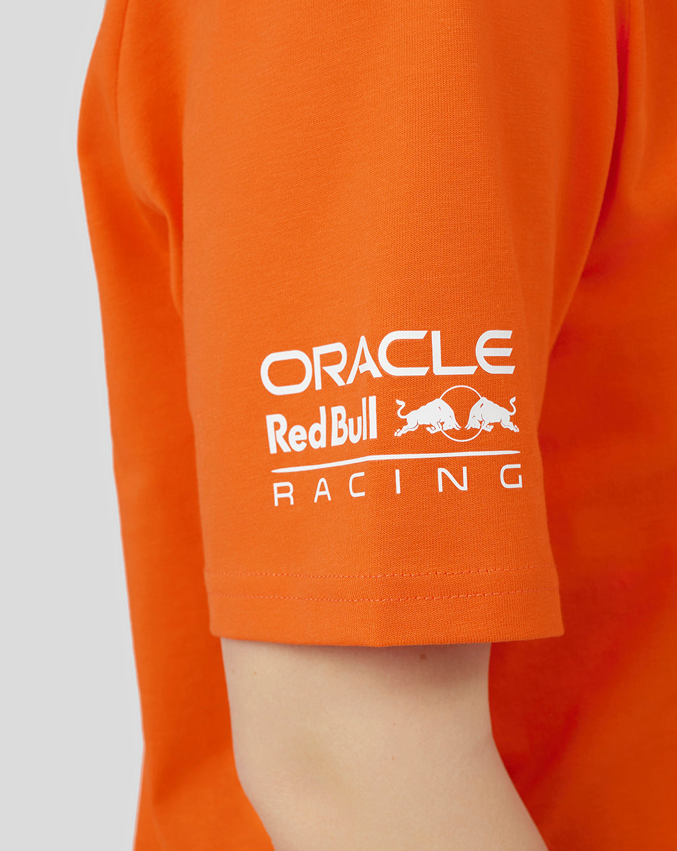 Orange T shirt sleeve close up showing Oracle Red Bull Racing logo in white