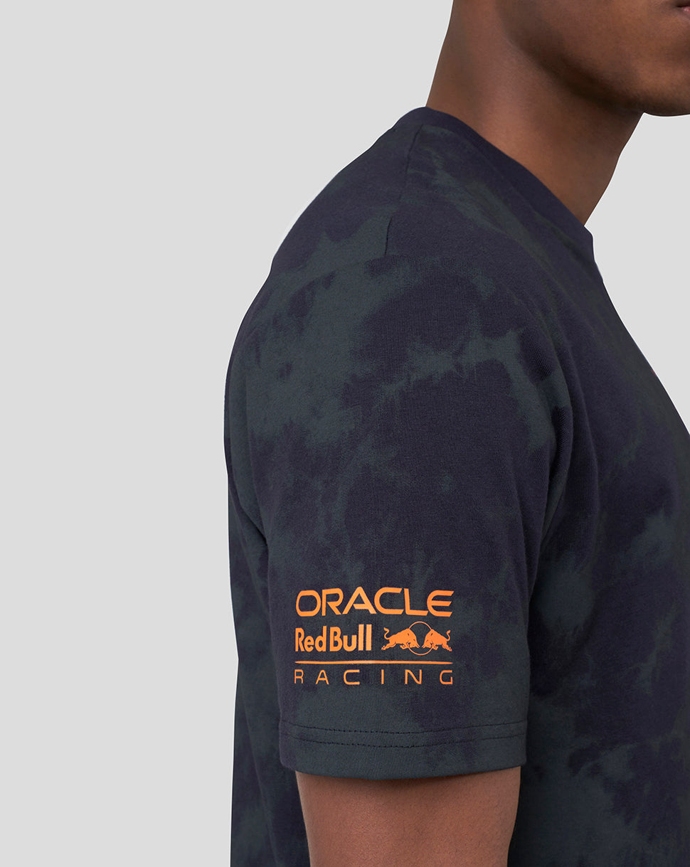 Side view of a model wearing a dark tie-dye Oracle Red Bull Racing T-shirt with orange branding on the sleeve