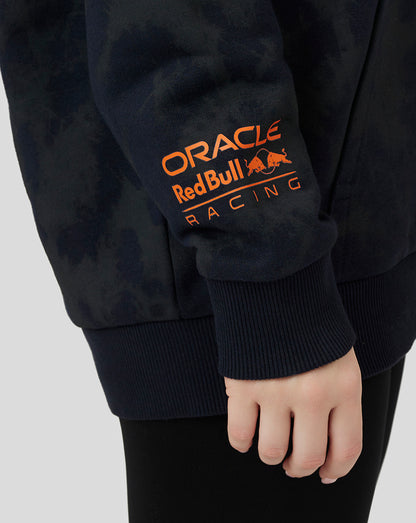 Close-up of hoodie sleeve showing orange Oracle Red Bull Racing logo tab on the hem.