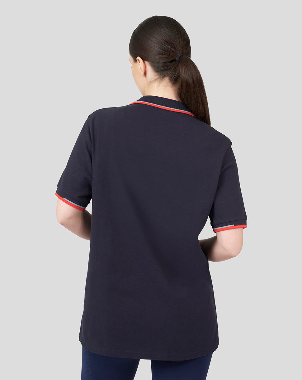 Back view of a model wearing a navy Oracle Red Bull Racing Unisex Core Polo with red tipped collar and cuffs