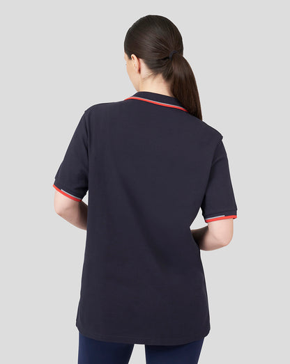 Back view of a model wearing a navy Oracle Red Bull Racing Unisex Core Polo with red tipped collar and cuffs