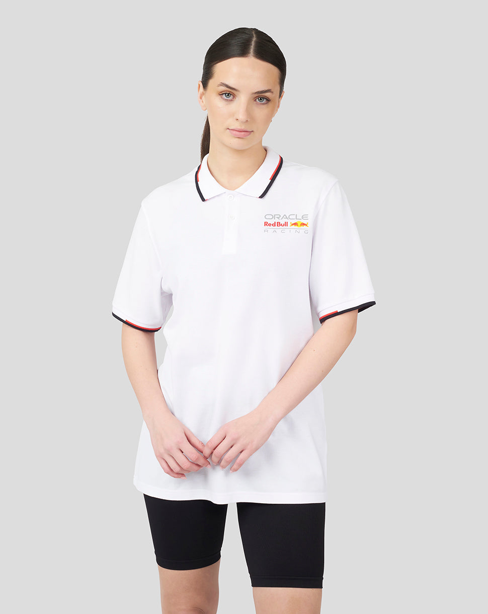 Model wearing white Oracle Red Bull Racing unisex core polo with contrasting tipped collar and branding on left chest.