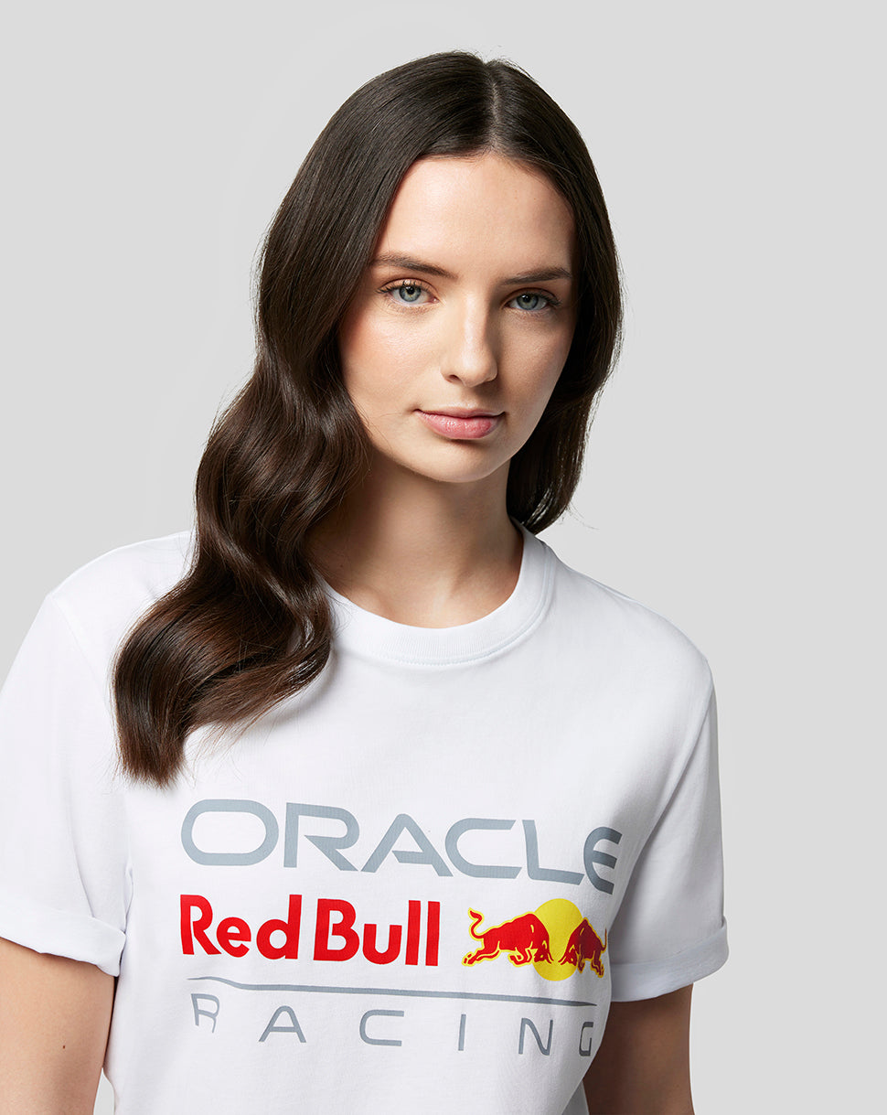 Close up of a woman wearing a white Oracle Red Bull Racing tee with a large chest logo.