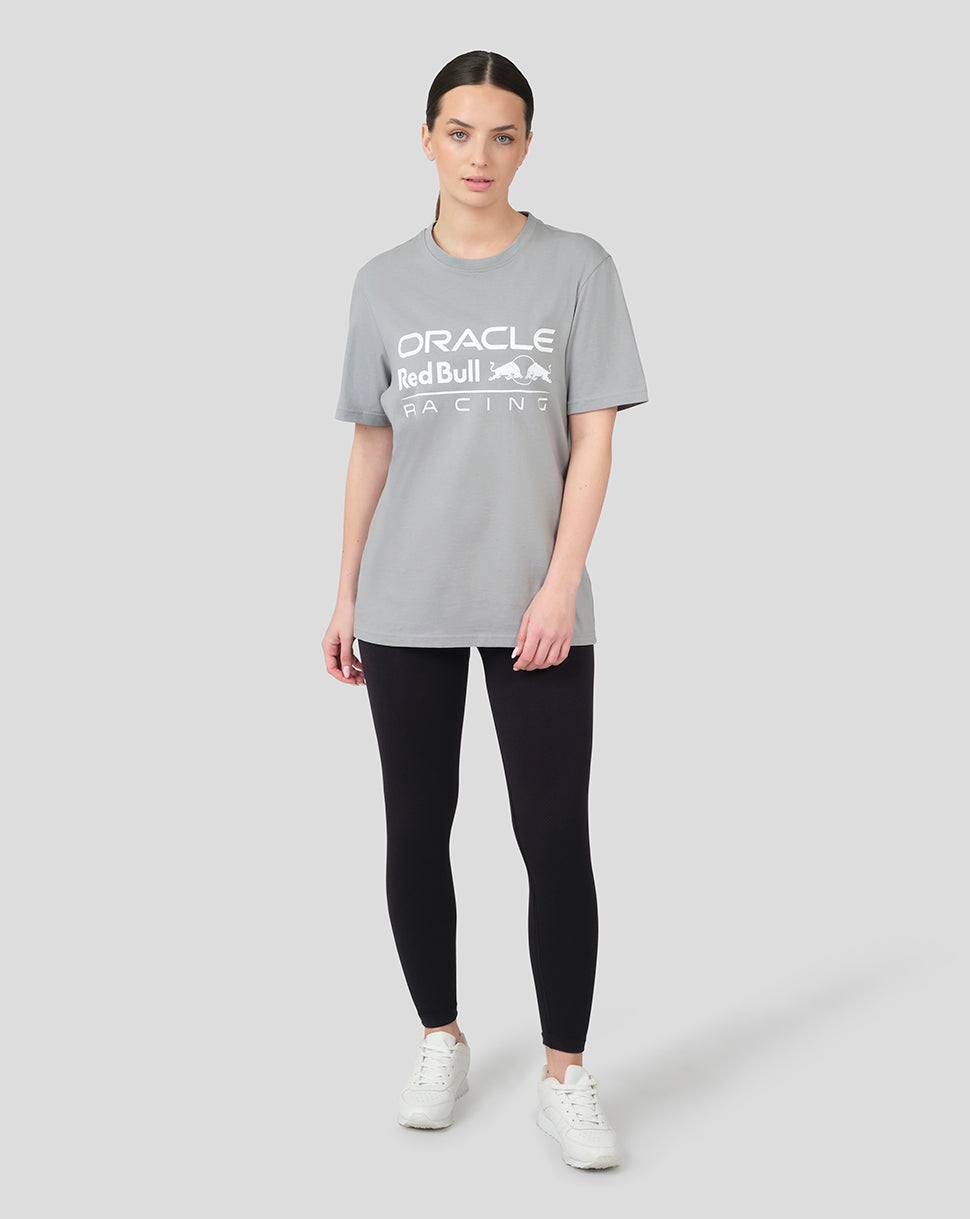 Model wearing grey Oracle Red Bull Racing T shirt with large front logo, black leggings and white sneakers.