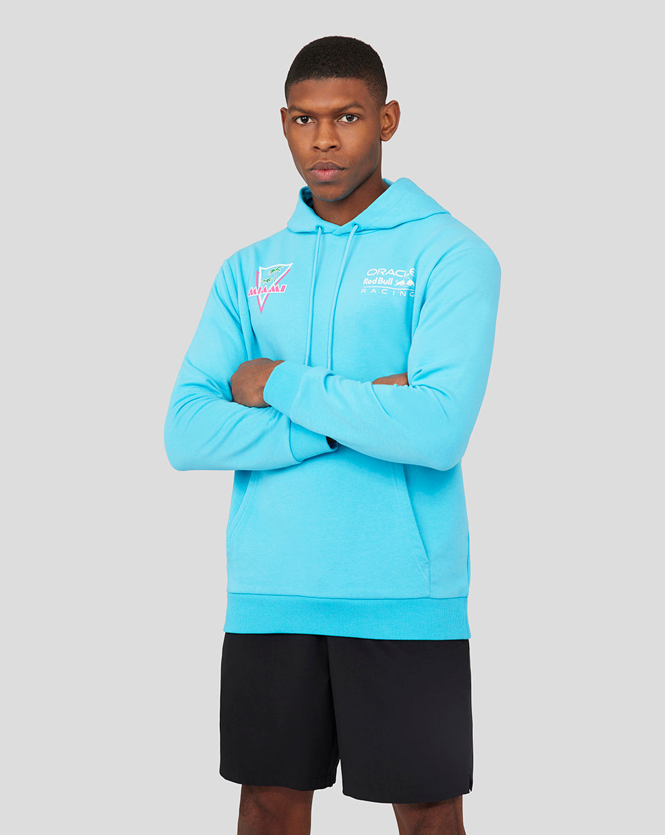 Male model wearing light blue Oracle Red Bull Racing Miami hoodie with chest logo