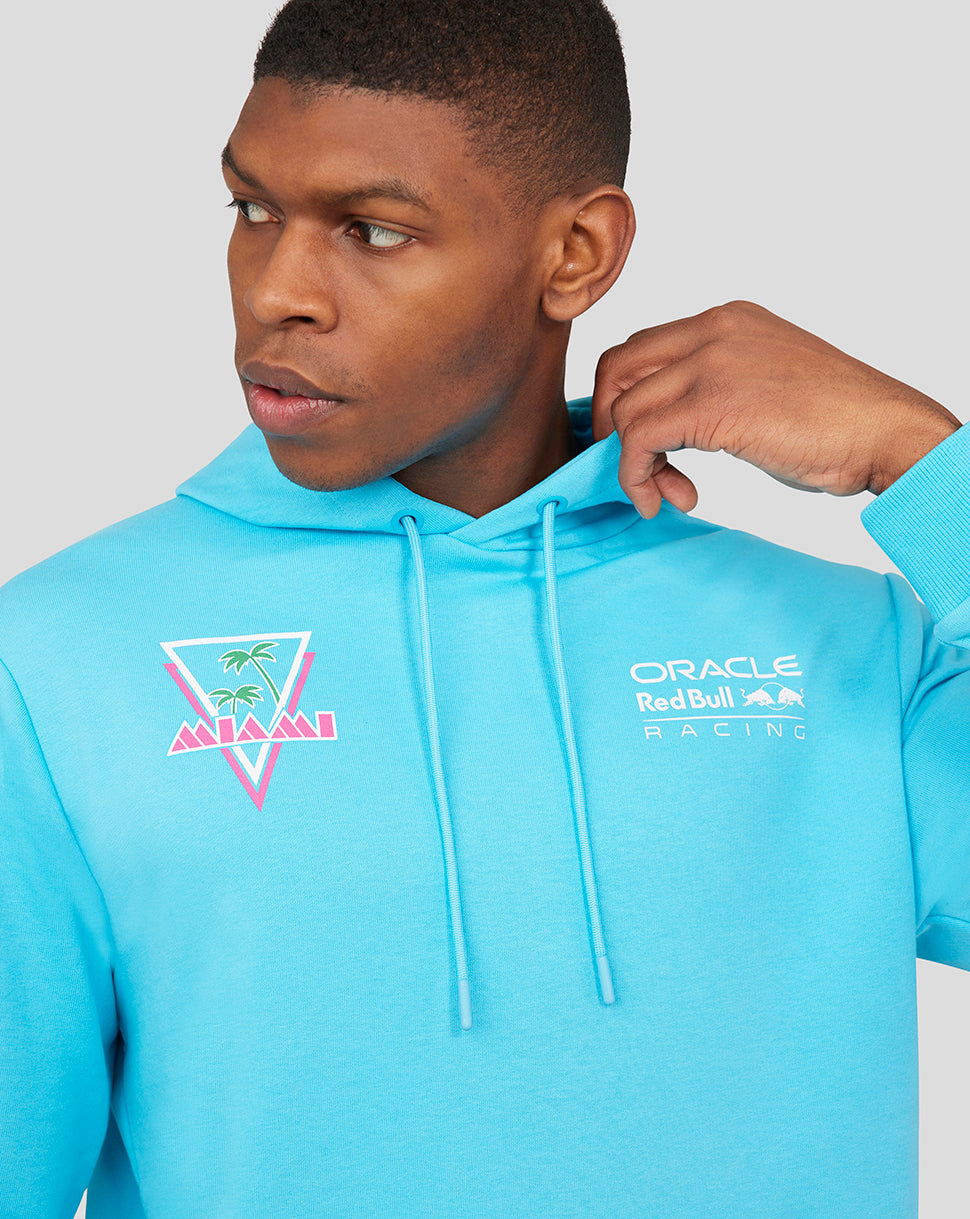 Profile view of a man wearing a light blue Oracle Red Bull Racing Miami hoodie with a white front logo