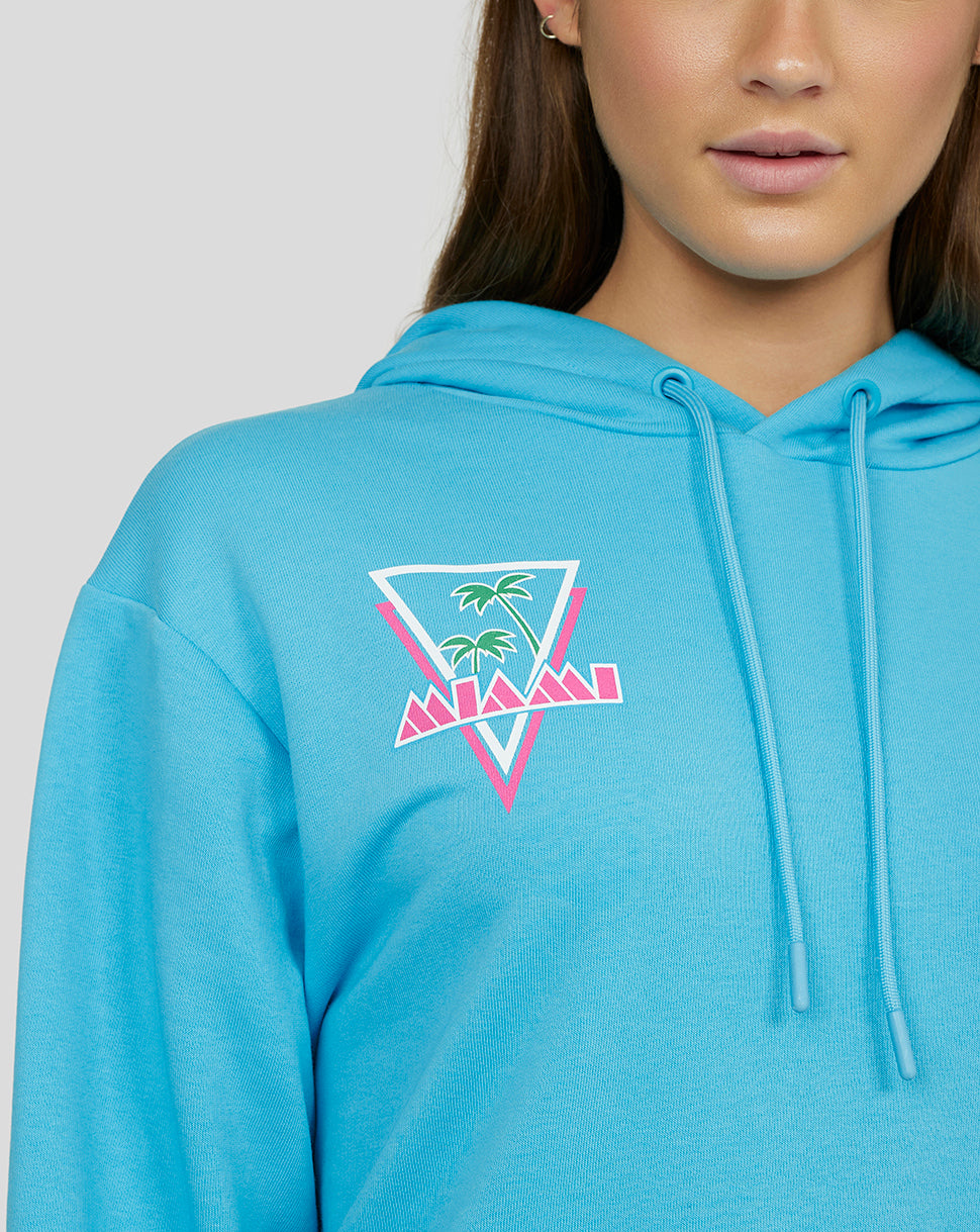 Close up of a turquoise River Blue Oracle Red Bull Racing hoodie with a Miami palm triangle graphic on the chest