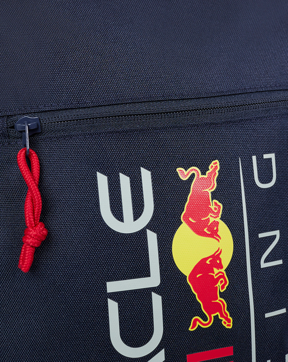 Close up of navy Night Sky backpack showing Red Bull logo on the front with a red cord zipper pull
